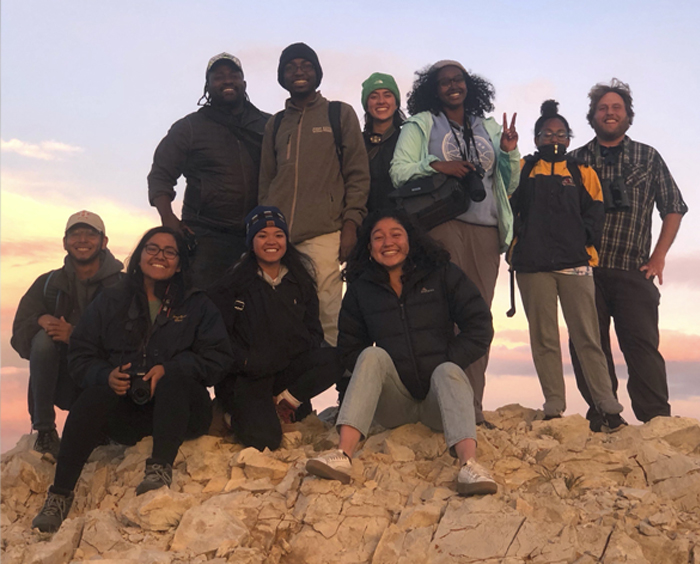 Group of diverse undergraduate students smile at the camera outdoors