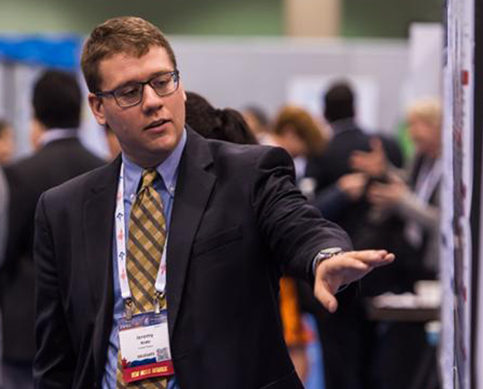 Postdoctoral fellow presents poster at a conference